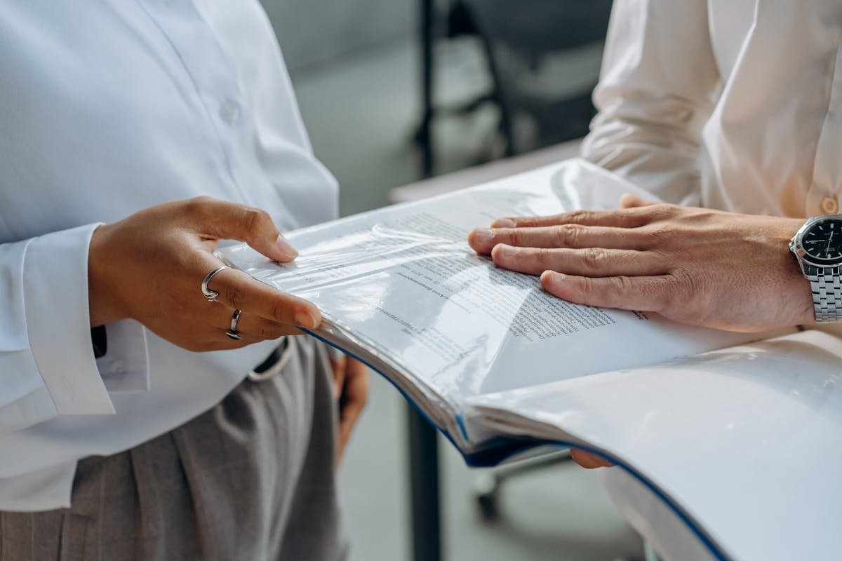 Professionals discussing business documents during due diligence support